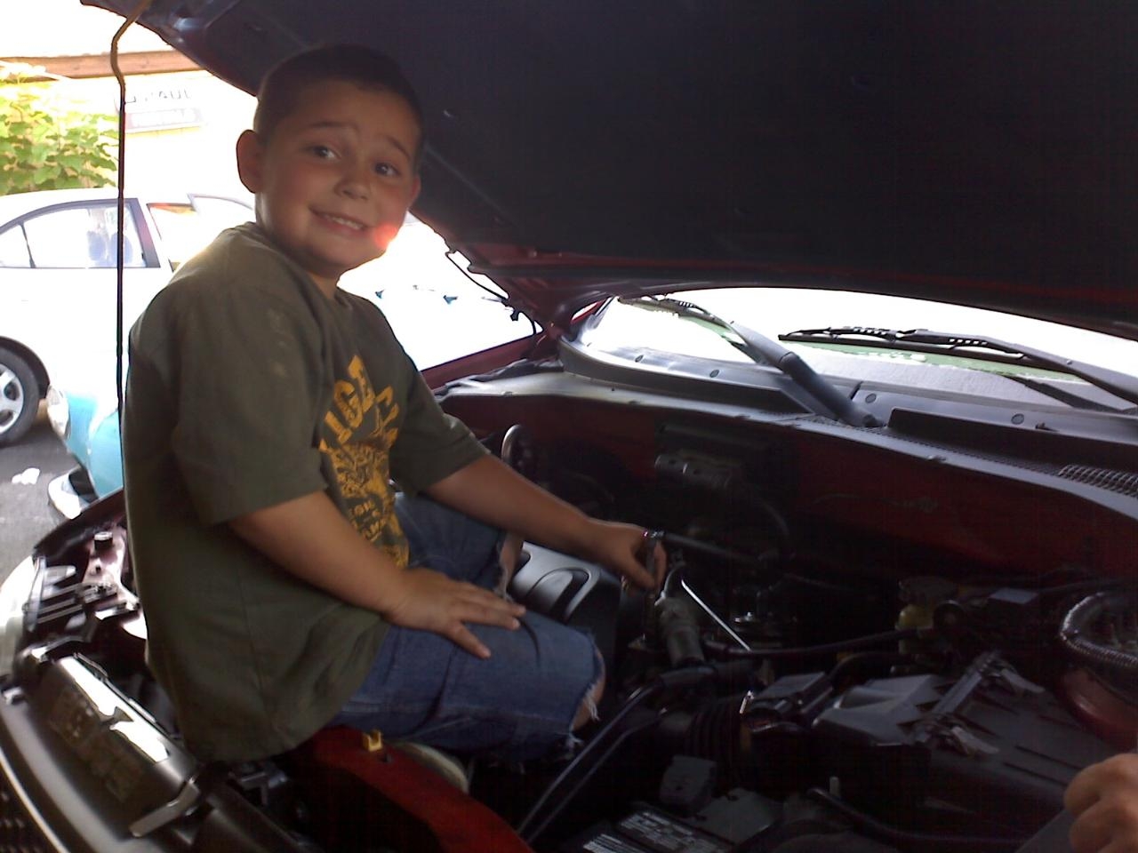 Devin helping Dad at the shop